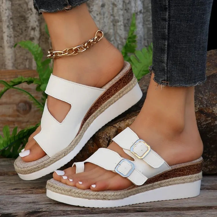 White patent leather wedge sandals with woven design and peep toe on rubber sole