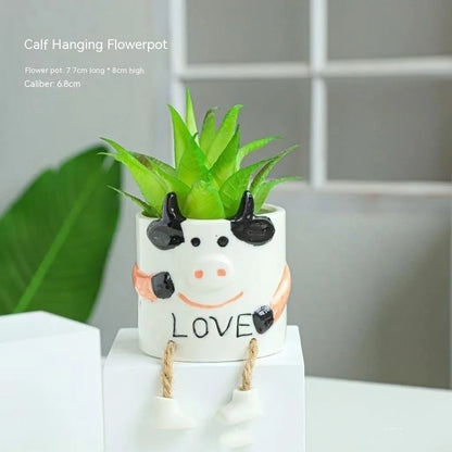 Ceramic hanging foot flowerpot with cartoon design for succulents on desktop