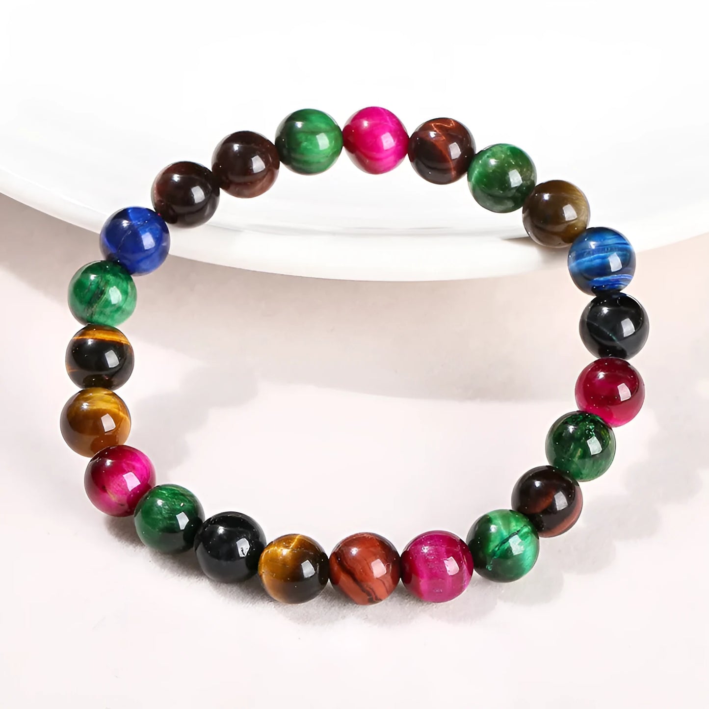 Colourful tiger-eye gemstone bracelet with round beads in 6mm, 8mm, 10mm, and 12mm sizes on mixed string
