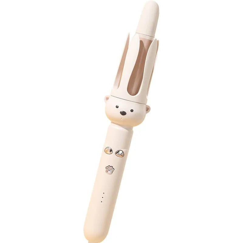 Beige automatic hair curler machine with negative ion technology and included styling stick on a table.