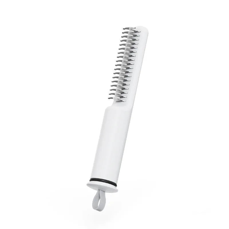 Pink and white stainless steel dematting comb for dogs on a plain background.