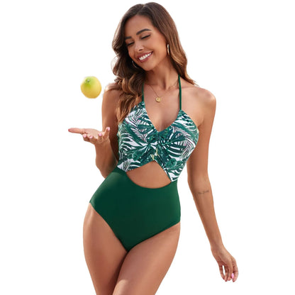 Women's black one-piece swimsuit with a colourful printed patchwork leaf design.