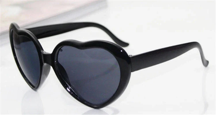Fashionable heart-shaped light-up glasses with a built-in LED lighting system, perfect for adding a touch of love and playfulness to any occasion.