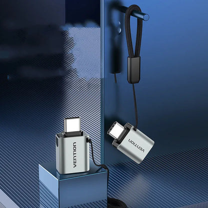 Grey aluminium alloy USB-C male to USB-A female OTG adapter with lanyard hole.