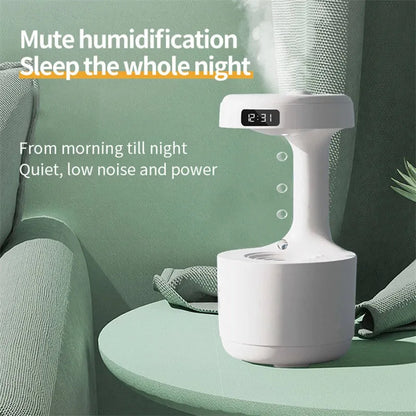White columnar anti-gravity humidifier with water droplet backflow and LED clock display on a desk.