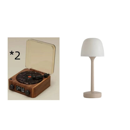 Retro-style turntable Bluetooth speaker with glowing RGB light projection on a wooden surface.