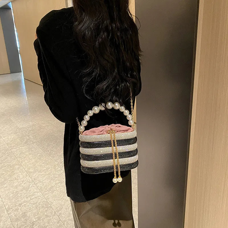 Women's one-shoulder crossbody bag with pearl beading, round shape, and internal zipper pocket in black colour