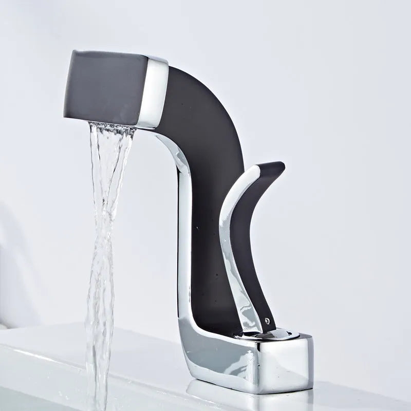 Copper vanity basin mixer tap with lift handle, shown in black and gold finish.