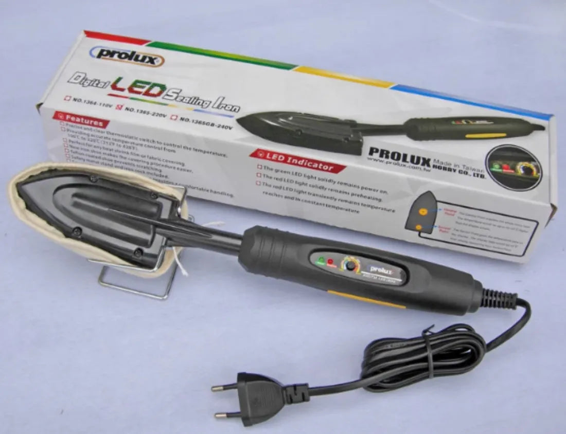 Electronic temperature control iron for styling wigs and hairpieces with metal barrel and PTFE soleplate.