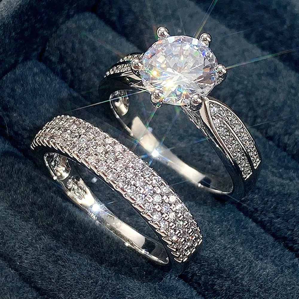 White gold-coloured geometric wedding ring with round elements on a finger