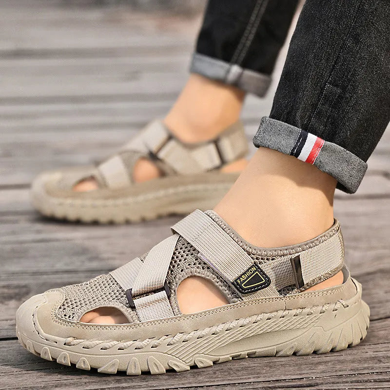 Men's gray casual sandals with mesh panels, leather upper, elastic strap, and rubber sole.
