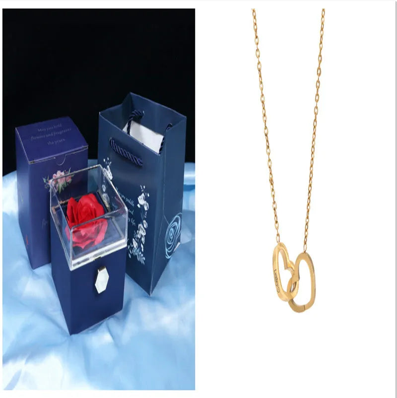 Rotating rose jewellery gift box with a preserved red rose under a clear acrylic dome, showing the interior rotating drawer.
