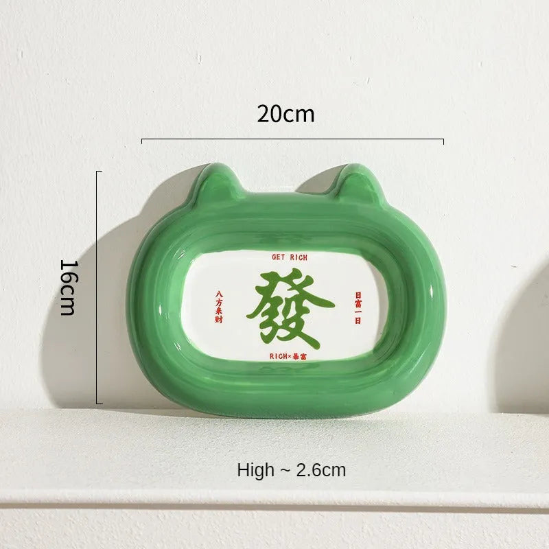 Four ceramic animal-themed pet bowls with frog, panda, pig, and fortune cat designs and silicone non-slip bases
