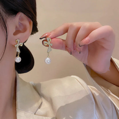 Elegant gold bow diamond crystal earrings for women, perfect for adding a touch of glamour to any outfit.