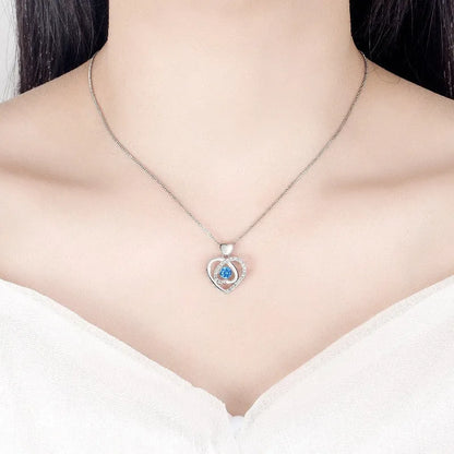 Blue diamond heart-shaped pendant necklace and matching bracelet set on a copper chain.