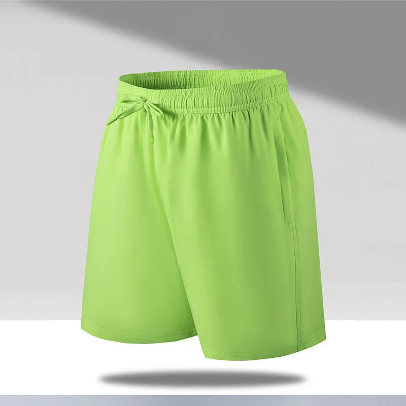 Man wearing black loose-fit quick-dry polyester sports shorts on a summer day.
