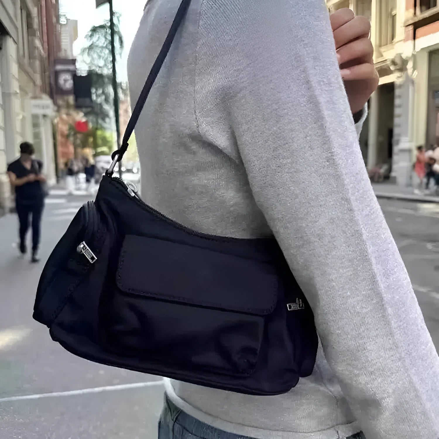 Black lightweight nylon shoulder bag with two pockets and side stitch detailing, dimensions 24cm x 9cm x 14cm.