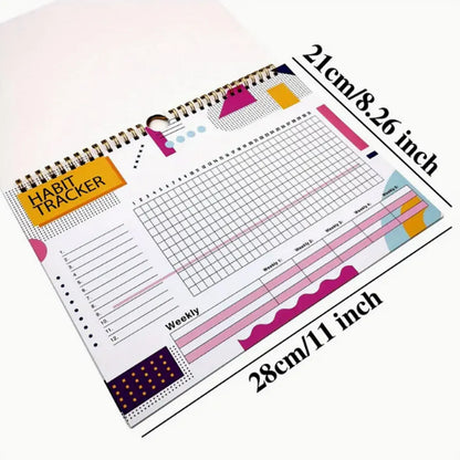 Habit tracking planner book open showing 12 internal pages, measuring 21cm by 28cm.