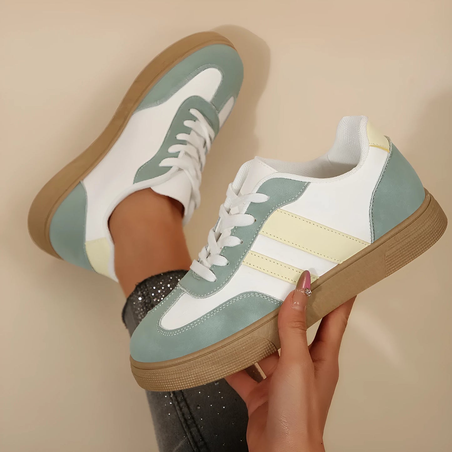 Women's green and white retro-style low-top casual pumps with cross straps and a flat rubber sole.