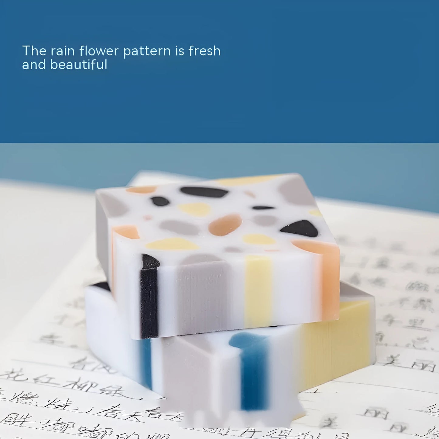 White rectangular rubber brick eraser for students on a blue background.