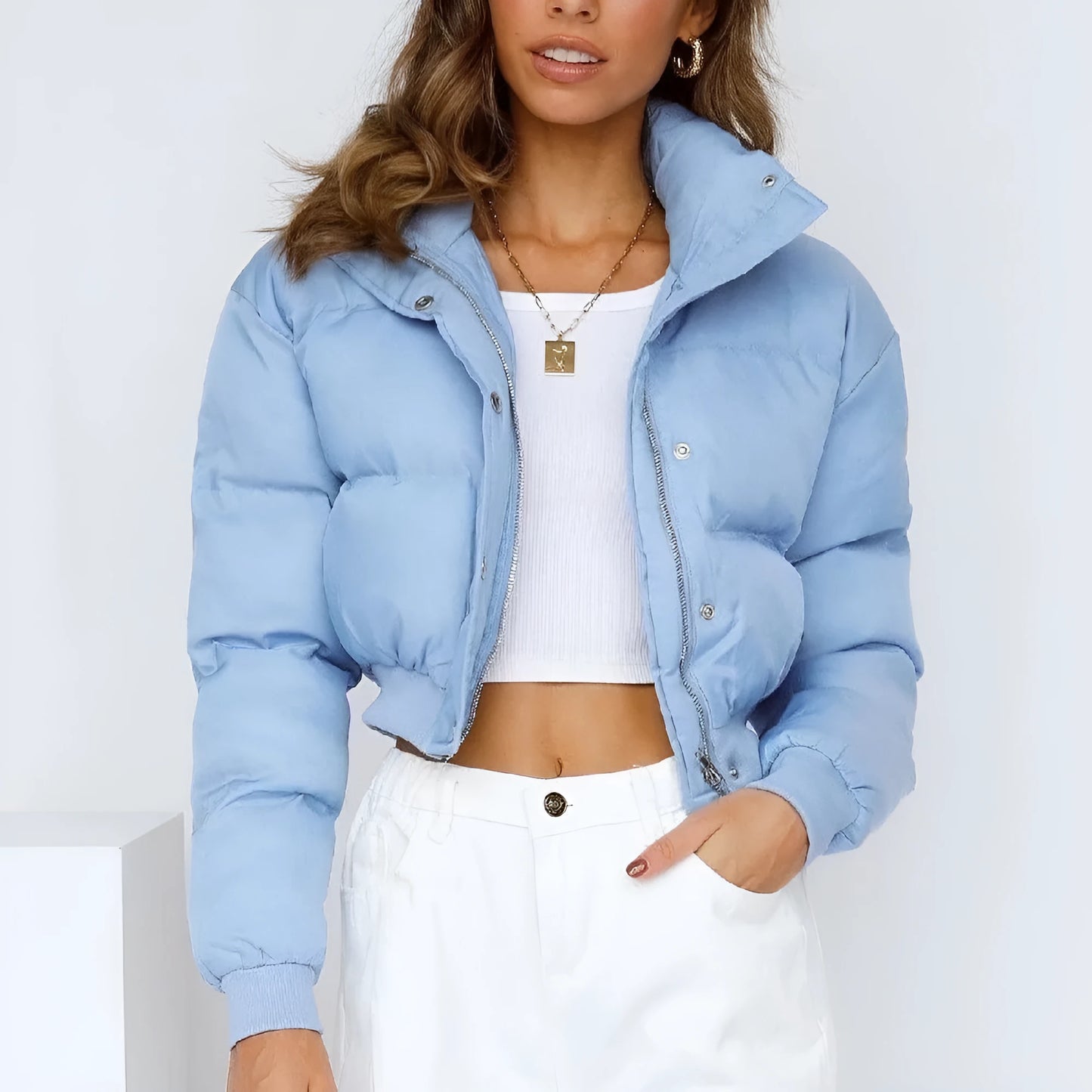 Loose blue polyester jacket for women on a hanger, showing long sleeves and front zip.