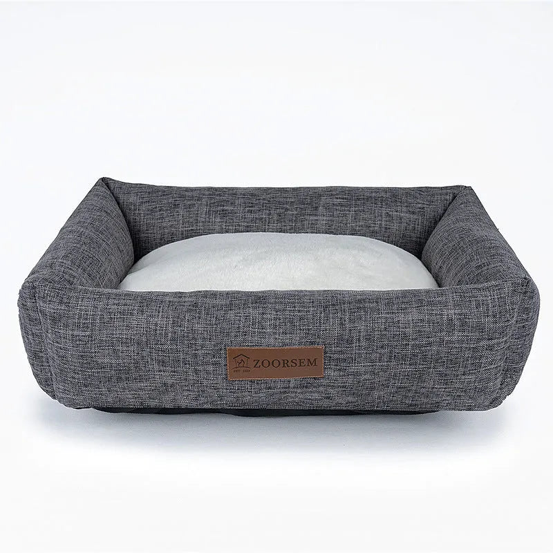 Grey linen-look square dog bed for medium-sized dogs on a wooden floor