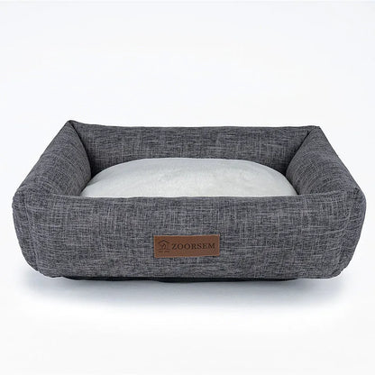 Grey linen-look square dog bed for medium-sized dogs on a wooden floor