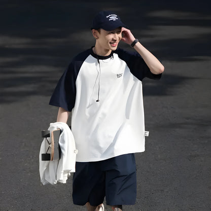 Men's blue loose-fit Japanese style long sleeve t-shirt with raglan sleeves on a hanger.
