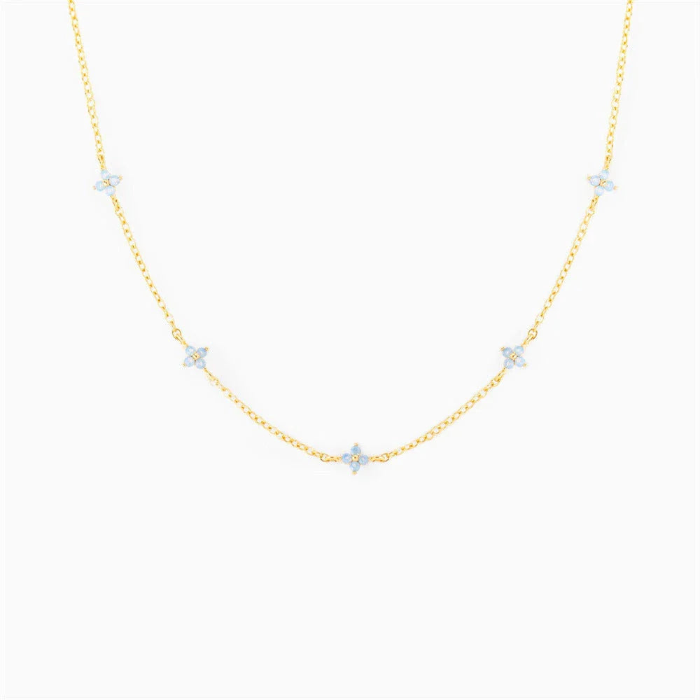 Elegant gold and silver floral necklace with adjustable chain and flower charm, perfect for vacation and beach outfits