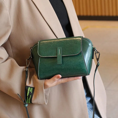 Women's brown oil wax cowhide leather messenger bag with crossbody strap and organised interior pockets