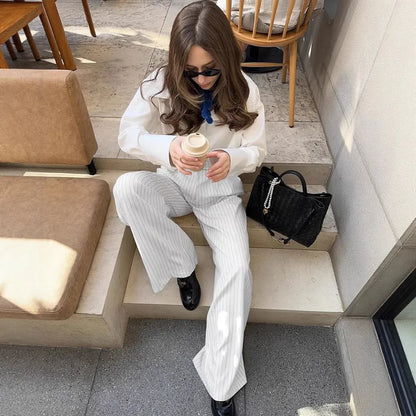 White women's wide-leg trousers with a striped pattern and zip detail, laid flat.