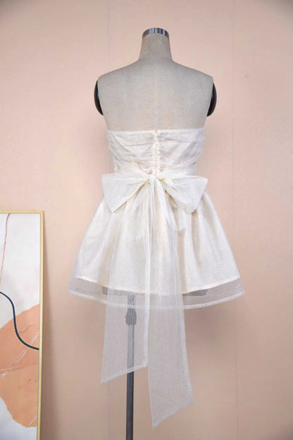 Elegant lace cocktail dress with graceful bow detail, available in various colours and sizes
