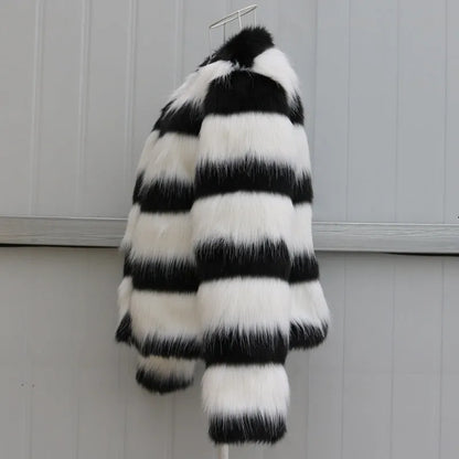 Womens black and white striped long-sleeved faux fur leather jacket on a hanger.