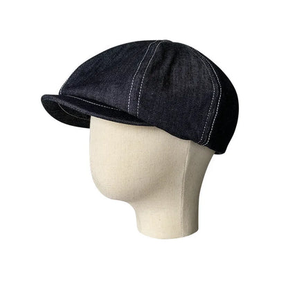 Black Japanese denim cotton beret hat showing octagonal cap style on neutral background