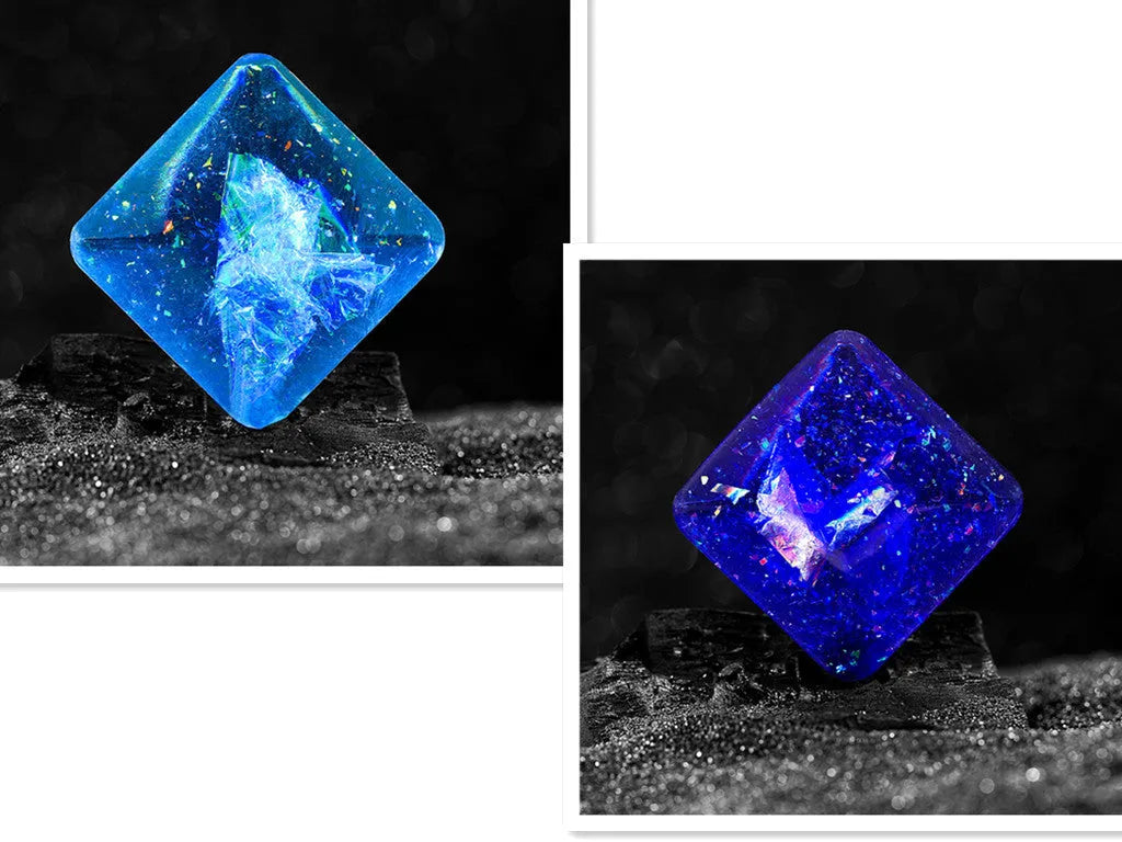 Galactic edition pocket gyro desk toy on a surface, showing its quadrilateral resin construction and celestial colour design.