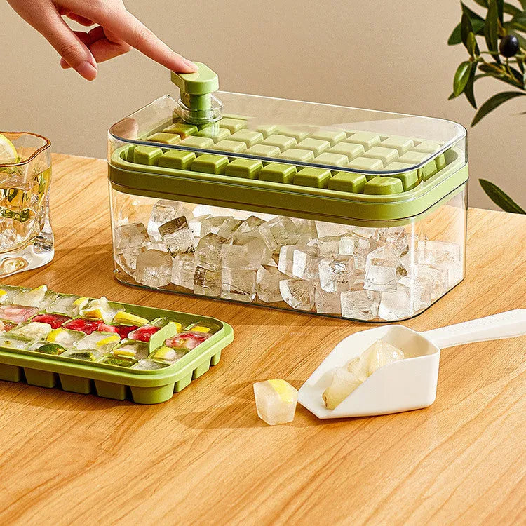 Green one-button press ice mould box with storage lid and ice shovel on kitchen counter
