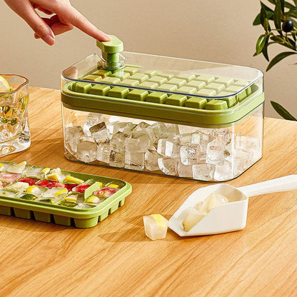 Green one-button press ice mould box with storage lid and ice shovel on kitchen counter
