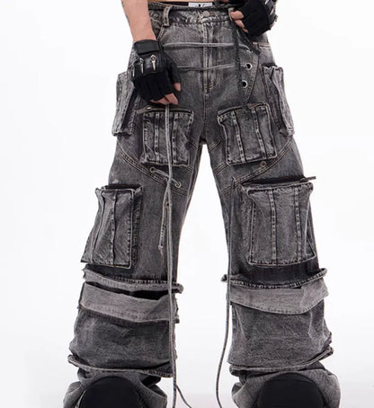 Grey distressed denim overalls jumpsuit with rope stitching on a hanger.