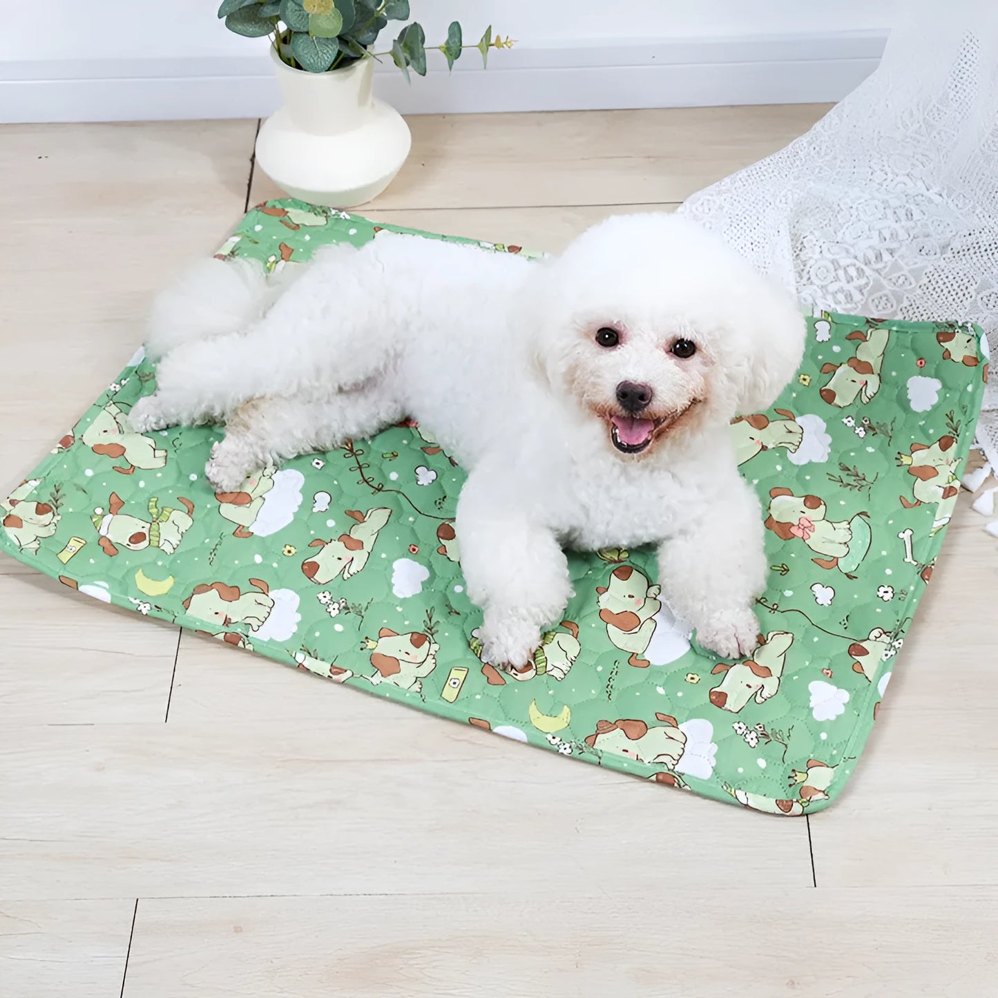 Reusable washable pet urine pad showing colourful animal pattern and waterproof backing.