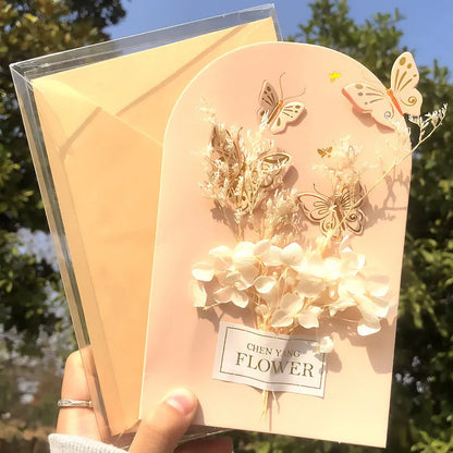Handmade 3D butterfly greeting card with stand-up artificial flowers on coated paper, 16x10.5cm