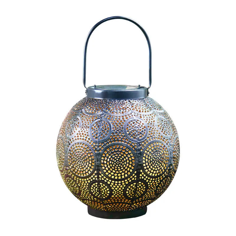 Solar-powered iron courtyard lamp with hollow decorative design and warm white LED lighting