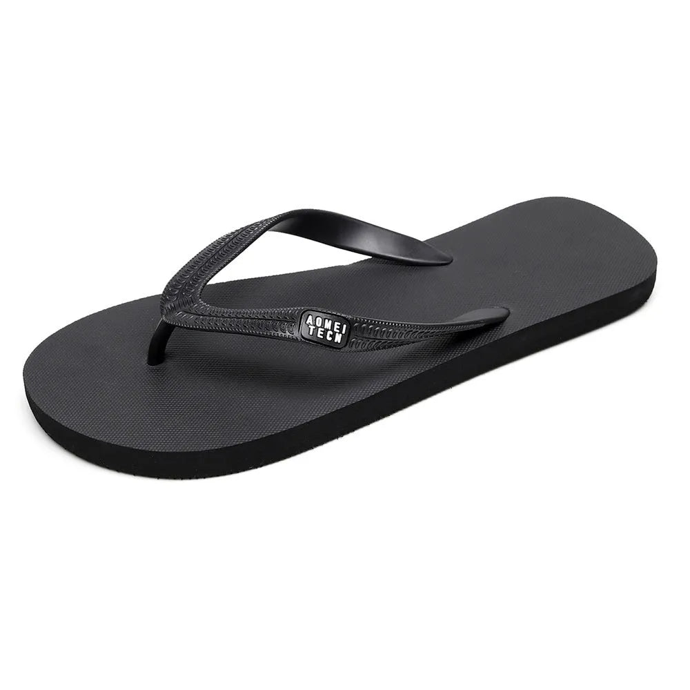Men's black flip-flop slippers with EVA upper and textured rubber sole on a sandy background.