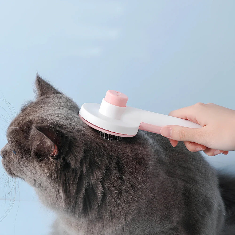 Self-cleaning cat comb with floating needle teeth and built-in hair storage chamber in assorted colours