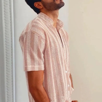 Pink men's short-sleeve waffle-knit shirt with a loose cardigan style on a hanger.