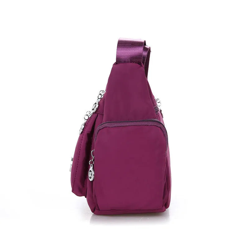 Women's nylon shoulder bag with multi-pocket design, zip opening and detachable handle in red, purple, black or army green