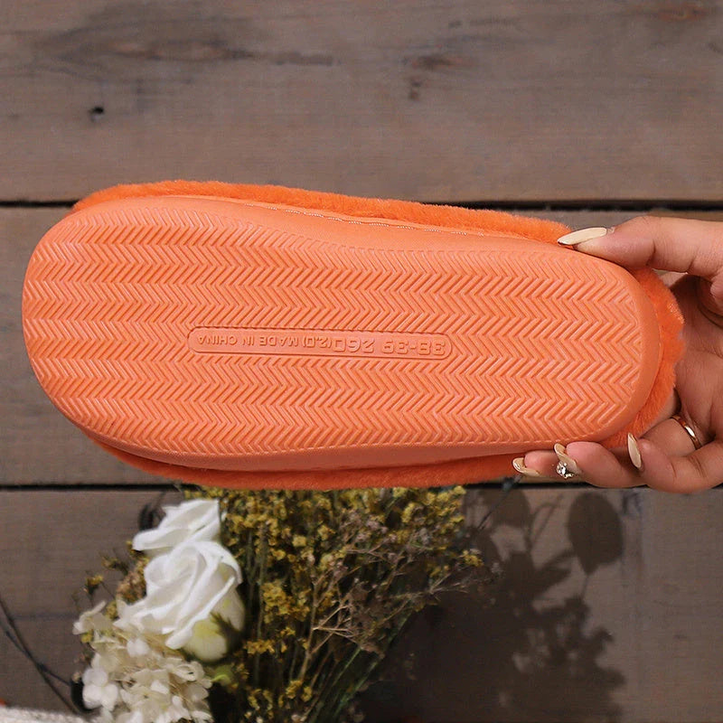 Cozy pumpkin-shaped slippers in orange color with plush fabric and non-slip sole for comfortable indoor wear