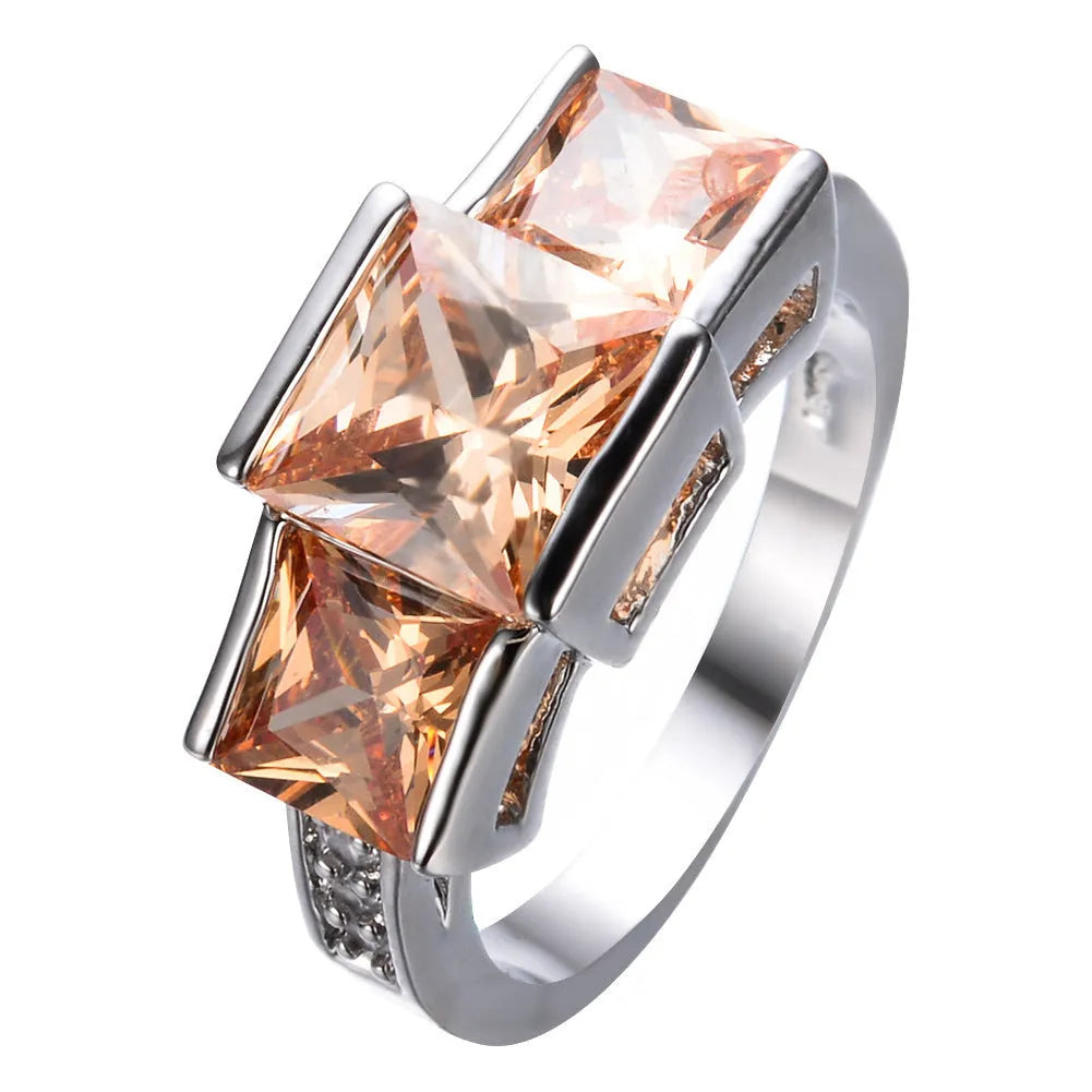 Aier Moxa geometric copper fashion ring in assorted electroplated colours on a plain background.