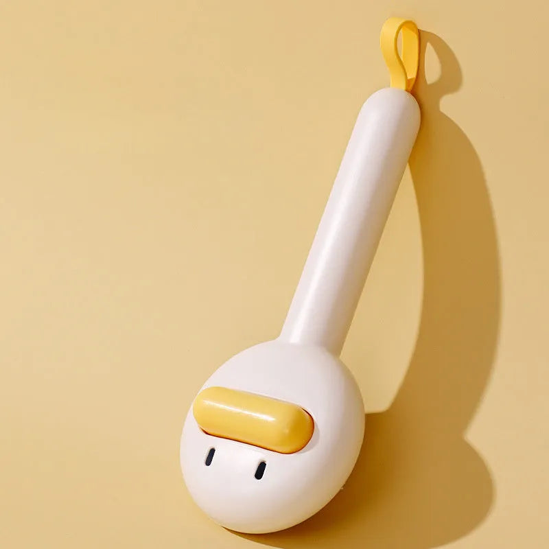 Small yellow duck-shaped plastic comb for grooming cats and dogs, with open needle teeth.
