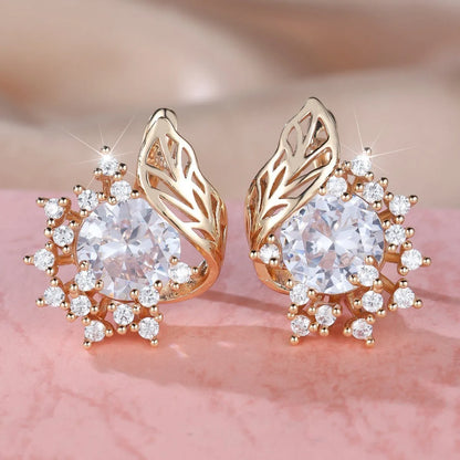 Rose gold plated women's stud earrings with a round flower shape, feather detail, and a central cubic zirconia stone.