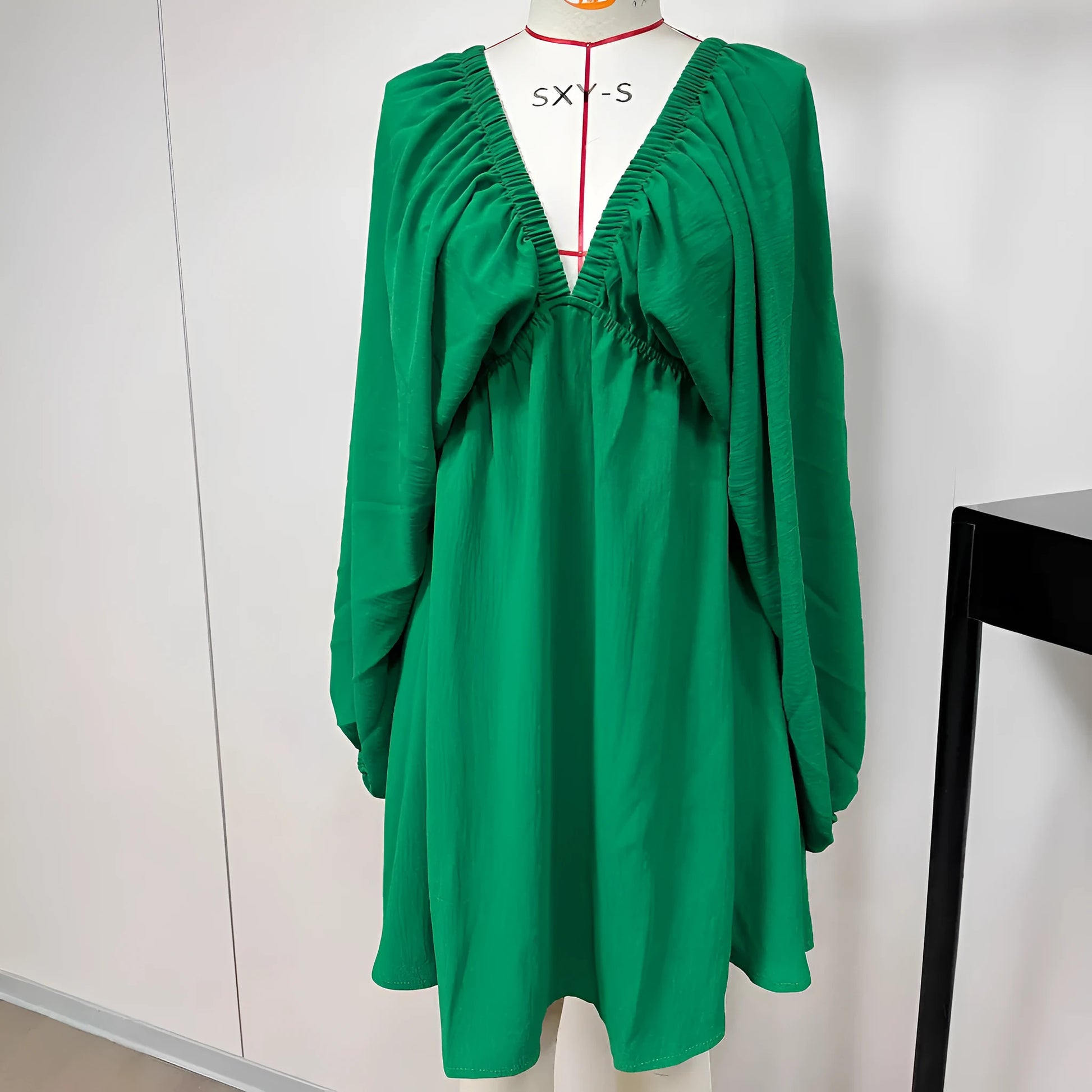 Women's apricot V-neck dress with long puff sleeves and a flounced swing skirt.